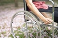 Patient woman using a wheelchair in a park hospital