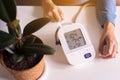 Patient woman using blood pressure and heart rate monitor for yourself at home Royalty Free Stock Photo