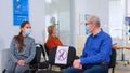 Patients with masks talking sitting on chairs keeping social distance