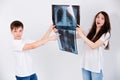 Patients view their pictures on a white background in the Studio