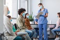 Patients Waiting For Covid-19 Vaccination Sitting In Line In Clinic