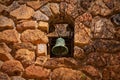 A patinated mission bell set in an old stone wall. Royalty Free Stock Photo