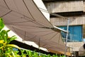 Patio awning. beige color canvas sun shade or sail. UV protection fabric tent suspended from steel frame Royalty Free Stock Photo