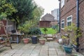 Patio, back garden with a wooden cabin at the back. Royalty Free Stock Photo