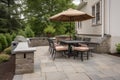 patio with built-in grill and seating for outdoor dining