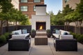 a patio with an outdoor fireplace and plush lounge chairs Royalty Free Stock Photo