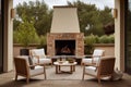 a patio with an outdoor fireplace and plush lounge chairs Royalty Free Stock Photo