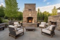 a patio with an outdoor fireplace and plush lounge chairs Royalty Free Stock Photo