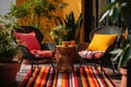 a patio with outdoor wicker chairs and colorful rug