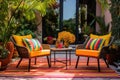 a patio with outdoor wicker chairs and colorful rug