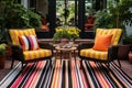 a patio with outdoor wicker chairs and colorful rug