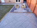 Patio in vitrified paving with gravel and railway sleepers planters