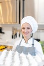 Patissier in her bakery shop with lots of meringue Royalty Free Stock Photo