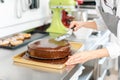 Patissier pouring liquid chocolate on a cake Royalty Free Stock Photo