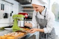 Patissier putting cocoa powder on little cakes Royalty Free Stock Photo