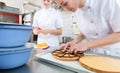 Patissier women working on fruit cake