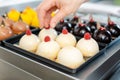 Patissier working on little chocolate desserts