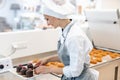 Patissier working on little chocolate desserts