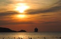 Patong, Phuket, Thailan - 11 December 2019 - blurred view sunset sky and sea, black silhouettes of floating people and a cruis