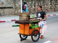 PATONG, PHUKET, THAILAND - JANUARY 22, 2020: Unidentified street vendor pushes her cart on a street of Patong, Thailand