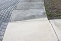 Patrially cleaned and partial irty cement sidewalk in front of a homeafter some of it has been pressure washed.