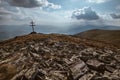 Patriarchal cross on the mountain summit with spectacular sun rays through the clouds. Low Tatras Nizke Tatry Crest Trail Royalty Free Stock Photo