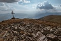 Patriarchal cross on the mountain summit with spectacular sun rays through the clouds. Low Tatras Nizke Tatry Crest Trail Royalty Free Stock Photo