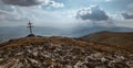 Patriarchal cross on a mountain top with spectacular sun rays through the clouds. Low Tatras Nizke Tatry Crest Trail landscape Royalty Free Stock Photo