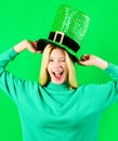 Patrick& x27;s Day celebration. Winking blonde girl in green top hat on Patricks Day. Patrick day party. Happy woman in