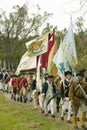 Patriot soldiers with flags march to Surrender Field as part of the 225th Anniversary of the Victory at Yorktown, a reenactment of Royalty Free Stock Photo
