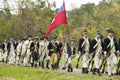 Patriot soldiers with flags march to Surrender Field as part of the 225th Anniversary of the Victory at Yorktown, a reenactment of Royalty Free Stock Photo