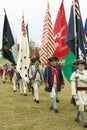 Patriot soldiers with flags march to Surrender Field as part of the 225th Anniversary of the Victory at Yorktown, a reenactment of Royalty Free Stock Photo