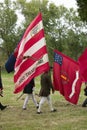 Patriot soldiers march with flags to Surrender Field as part of the 225th Anniversary of the Victory at Yorktown, a reenactment of Royalty Free Stock Photo