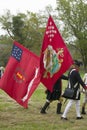 Patriot soldiers march with flags to Surrender Field as part of the 225th Anniversary of the Victory at Yorktown, a reenactment of Royalty Free Stock Photo