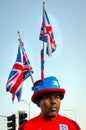 Patriotic Black British man with British Flag at the back