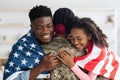 Patriotic black family greeting their mother soldier, closeup photo Royalty Free Stock Photo