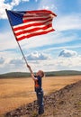 Patriotic boy with American flag Royalty Free Stock Photo