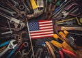 Patriotic collection of worn and used work tools with small US American flag. Made in USA, American workforce, or Labor Day