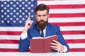 Patriotic concept. American lawyer teacher or tv host hold book american flag background. Love homeland. Man with beard Royalty Free Stock Photo