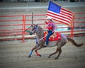 Patriotic Cowgirl on Horseback with Flag Royalty Free Stock Photo