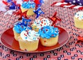 Patriotic cupcakes wih red, white and blue decorations.