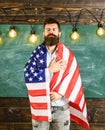 Patriotic education concept. American teacher covered with american flag. Teacher teaches to love homeland, USA. Man Royalty Free Stock Photo