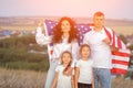 Patriotic family holds USA flag standing against rural area Royalty Free Stock Photo