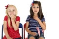 Patriotic girls holding an American flag with funny expressions