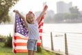 Patriotic holiday. Happy family, mother and daughter with American flag outdoors on sunset. USA celebrate independence Royalty Free Stock Photo