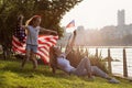 Patriotic holiday. Happy family, mother and daughter with American flag outdoors on sunset. USA celebrate independence Royalty Free Stock Photo