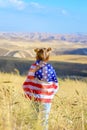 Patriotic holiday. Happy kid, cute little child girl with American flag. USA celebrate 4th of July.