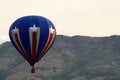 Patriotic Hot Air Balloon in the Mountain Sky Royalty Free Stock Photo