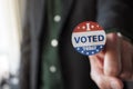 Patriotic man with I Voted today sticker on his finger