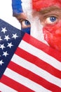 Patriotic man peering over an American flag Royalty Free Stock Photo